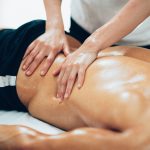 Sports massage. Therapist massaging lower back